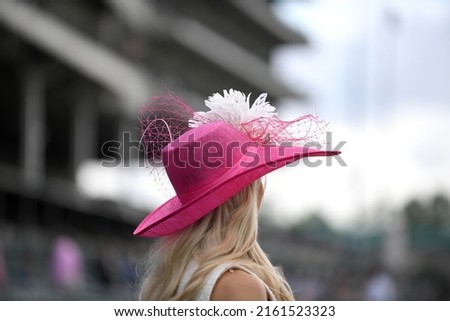 Elegant hats at a horse race  Royalty-Free Stock Photo #2161523323