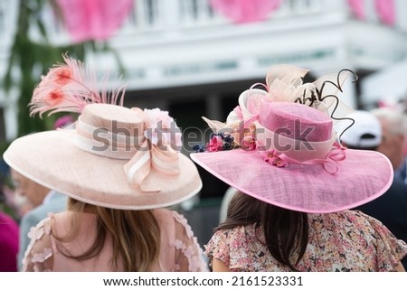 Elegant hats at a horse race  Royalty-Free Stock Photo #2161523331