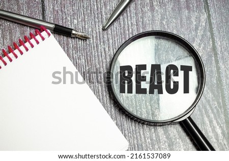 magnifying glass with the text react javascript library Royalty-Free Stock Photo #2161537089