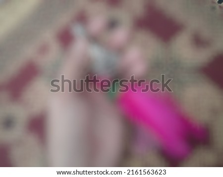 Defocused or blurred abstract background of a key and its pink accessories put on the decorative table