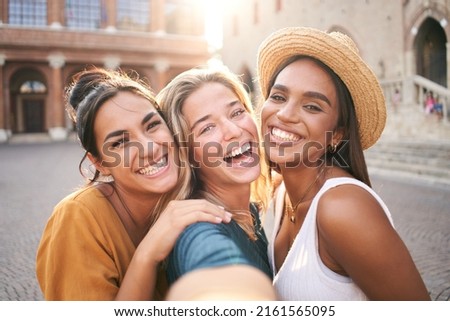 Three young smiling hipster women in summer clothes. Girls taking selfie self portrait photos on smartphone.Models posing in the street.Female showing positive face emotions Royalty-Free Stock Photo #2161565095