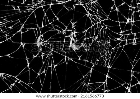old dirty glass with a lot of cracks, old broken glass on a black background