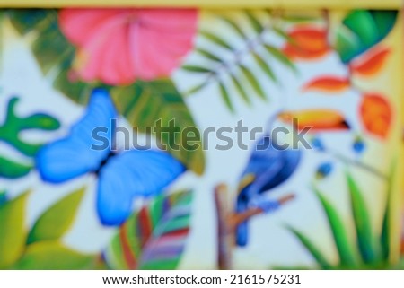 Blurred image of blue butterfly on a wall close-up background