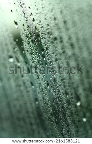 Macro texture of dew on glass surface