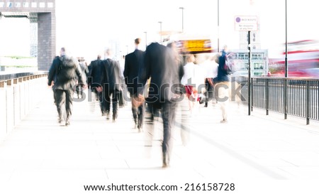 Rush hour commuters. Long exposure, high key abstract of anonymous London City workers with intentional motion blur providing movement.