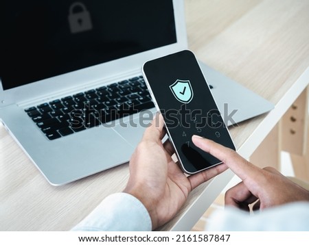 Two factor authentication or 2FA concept. Safety shield icon while access on phone with laptop for validate password, Identity verification, cybersecurity with biometrics authentication technology. Royalty-Free Stock Photo #2161587847