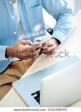 Two factor authentication concept. Virtual safety shield icon while access on phone with laptop for validate password, Identity verification, cybersecurity with biometrics authentication technology. Royalty-Free Stock Photo #2161588393