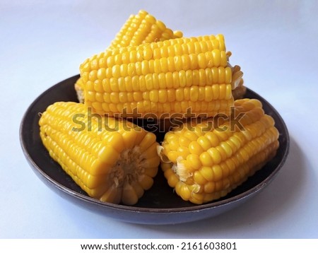 Boiled sweet corn is a snack when gathering with family or friends. It tastes delicious, healthy and nutritious. Royalty-Free Stock Photo #2161603801