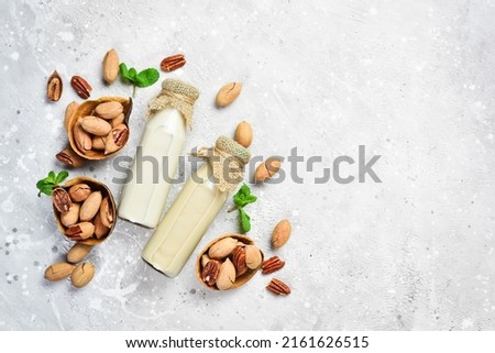 Pecan nut milk. Dairy free, lactose free milk. Top view. Vegan drinks. Royalty-Free Stock Photo #2161626515