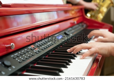 Modern electronic piano, hands on the keys, play, art school