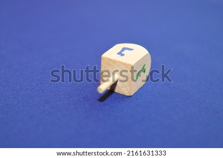 Wooden spinner for the Jewish game of dreidel