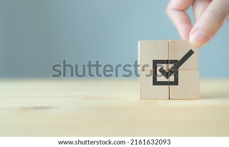 Corporate regulatory and compliance. Goals achievement and business success. Task completion. Ethical corporate. Do the right thing. Quality and ISO symbol. Placing wooden cube with checkmark icon.