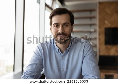 Head shot of confident friendly business professional looking at camera during online virtual conference, video call. Screen view portrait of millennial business man, employee, teacher giving webinar Royalty-Free Stock Photo #2161635033