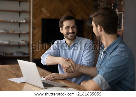 Happy client thanking broker for consultation, shaking hand. Employer, boss welcoming and hiring candidate at job interview. Confident business men giving handshakes after negotiations on meeting Royalty-Free Stock Photo #2161635055