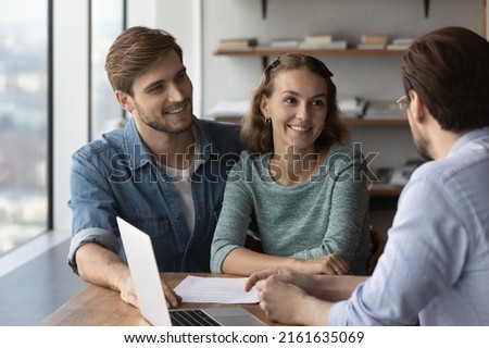Happy young couple of clients buying, renting apartment, meeting with banker, broker for signing mortgage agreement, rental contract, consulting agent. Real estate, property purchase