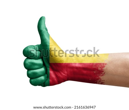 Hand making thumb up painted with flag of benin