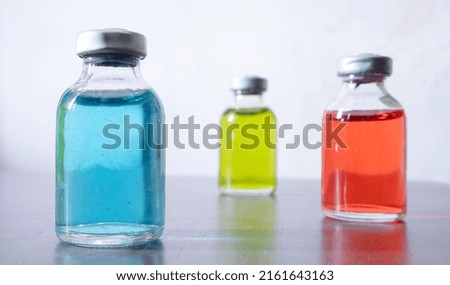 The three colored solution containing vials. Royalty-Free Stock Photo #2161643163