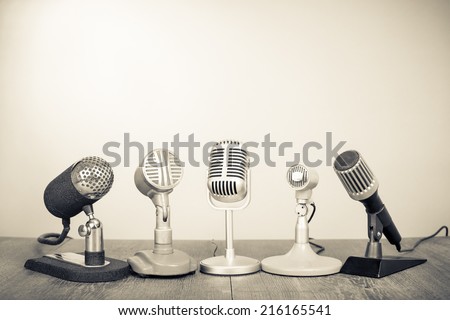 Retro microphones for press conference or interview. Vintage old style sepia photography Royalty-Free Stock Photo #216165541
