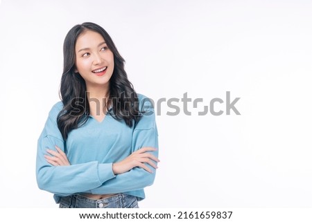 Confident success asian woman standing arms crossed on white background. Positive charming young girl wear casual smiling arms crossed looking copy space over isolated. Successful occupation lifestyle