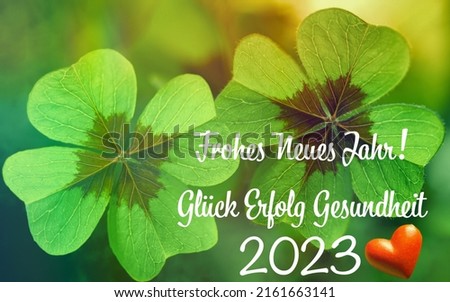 Decoration with four leaf clover and heart for New Year 2023 with text in german FROHES NEUES JAHR 2023 Glück Erfolg Gesundheit means in english HAPPY NEW YEAR 2023 LUCK SUCCESS HEALTH