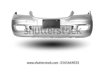 Silver car bumper with a black plastic panel on an isolated background, part for installation on a car body after repair and painting during repair in a workshop. Equipment for sale. Royalty-Free Stock Photo #2161664033