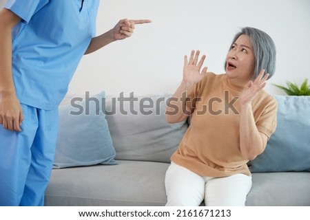 angry caregiver blaming or mistreating senior woman when she mistake something Royalty-Free Stock Photo #2161671213
