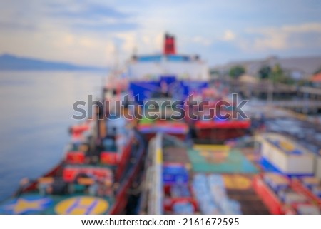 defocus and blurred image background of ships leaning at the port of Tanjung Wangi, Banyuwangi. fishing boats, supply ships and passenger ships. Harbourscape in the morning, aesthetic photo of jetty