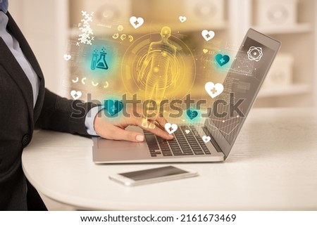 Doctor working on laptop with healthcare concept