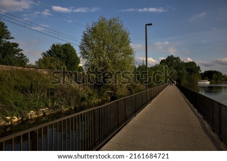 Bridge over a lake in a park at sunset