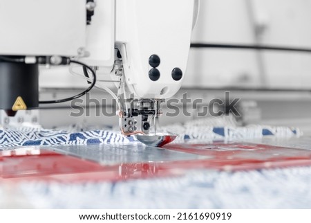 Automatic sewing machine for pocket, background white color. Concept Interior of garment factory.