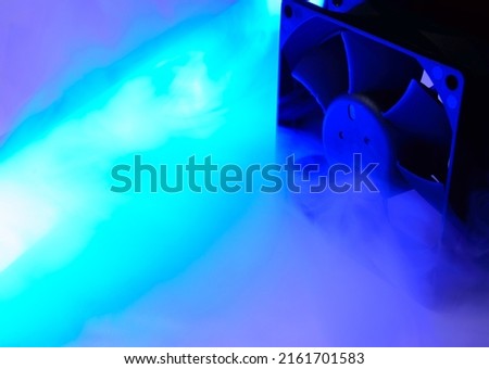 Computer air cooler in a neon blue smoke - close up photo. Background abstract picture.