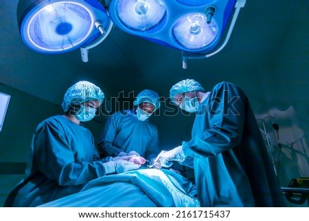 Team of surgeon doctors are performing heart surgery operation for patient from organ donor to save more life in the emergency surgical room Royalty-Free Stock Photo #2161715437