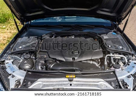 A modern diesel engine with 170 horsepower and an engine capacity of 2.2 liters. Visible engine components, fluids and electrical cables, the engine is covered. Royalty-Free Stock Photo #2161718185
