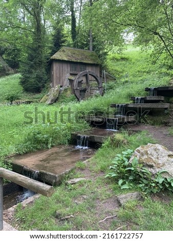 Picture of water mill with water feature of trickling stream 