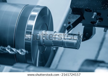 The  CNC lathe machine forming  cutting the metal shaft parts. The hi-technology metal working processing by CNC turning machine . Royalty-Free Stock Photo #2161724157