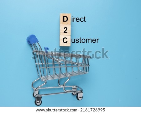 A picture of wooden block written D2C with shopping cart. Direct to Customer concept