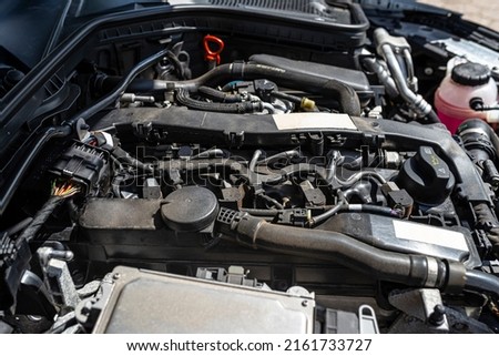 A modern diesel engine with 170 horsepower and an engine capacity of 2.2 liters. Visible engine equipment, spark plugs and electric wires. Royalty-Free Stock Photo #2161733727