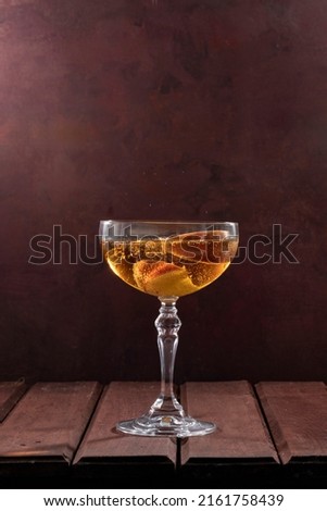 Rose apple cider in a glass on a brown wooden table with apple slices in glass Royalty-Free Stock Photo #2161758439