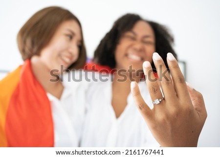 Diversity African American and Asian Married couples Lesbian LGBTQ. Married homosexual show Diamond ring.Sexual equality,LGBT Pride month,Parade celebrations concept.Family of happiness smiling. Royalty-Free Stock Photo #2161767441