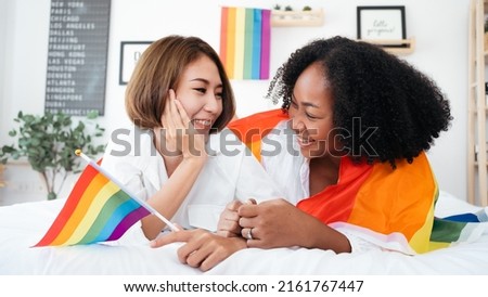 Diversity African American and Asian Married couples Lesbian LGBTQ. Married homosexual show Diamond ring.Sexual equality,LGBT Pride month,Parade celebrations concept.Family of happiness smiling. Royalty-Free Stock Photo #2161767447