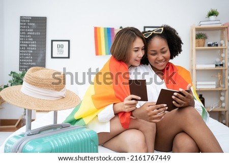 Diversity African American and Asian Married couples Lesbian LGBTQ. Married homosexual show their passports to prepare for a trip together.Sexual equality,LGBT Pride month,Parade celebrations concept. Royalty-Free Stock Photo #2161767449