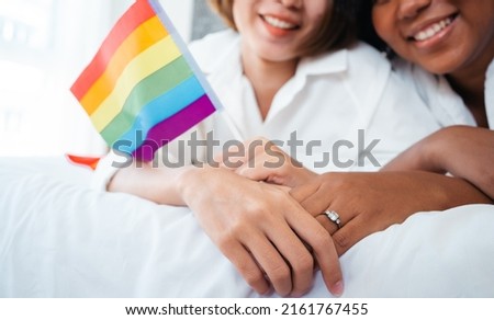 Diversity African American and Asian Married couples Lesbian LGBTQ. Married homosexual show Diamond ring.Sexual equality,LGBT Pride month,Parade celebrations concept.Family of happiness smiling. Royalty-Free Stock Photo #2161767455