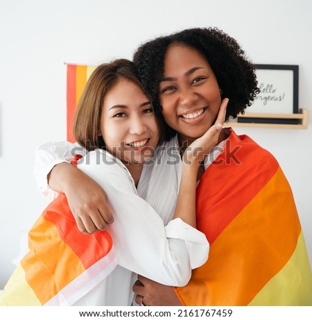 Diversity African American  Asian Married couples Lesbian LGBTQ.Engaged homosexual Hug together Rainbow flag.Sexual equality,LGBT Pride month,Parade celebrations concept.Family of happiness smiling. Royalty-Free Stock Photo #2161767459