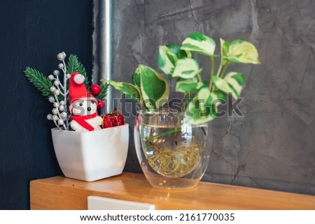 Bare plaster walls and table vase,   snowman christmas decorations