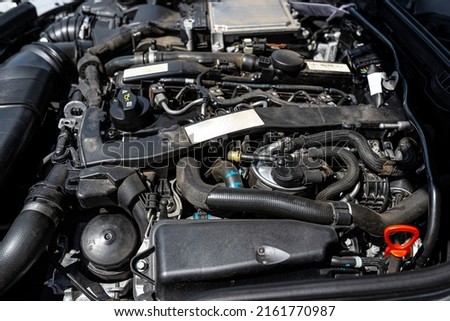 A modern diesel engine with 170 horsepower and an engine capacity of 2.2 liters. Visible engine equipment, spark plugs and electric wires. Royalty-Free Stock Photo #2161770987