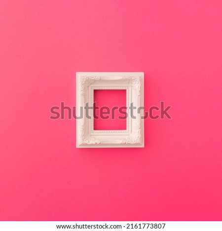 White vintage frame on vibrant pink background. Retro style, pop art concept.