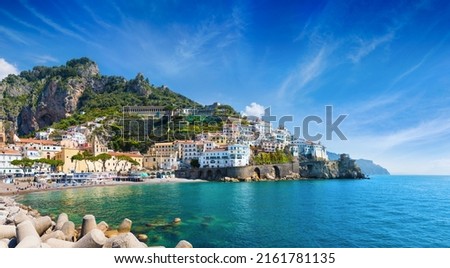 Panoramic view of beautiful Amalfi on hills leading down to coast, comfortable beaches and azure sea in Campania, Italy. Amalfi is most popular travel and holyday destination in Europe. Royalty-Free Stock Photo #2161781135