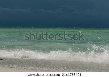 Turquoise blue ocean view white sand beach low point view 