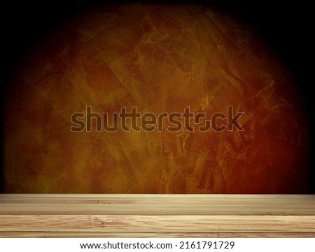 Old wooden table and stucco wall of brown color. Empty wooden table top with dark brown concrete wall background. Rustic wooden board on darken backdrop. Product display template. Copy space for text Royalty-Free Stock Photo #2161791729