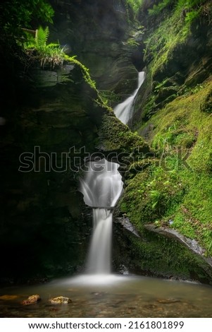 Long exposure shot of the waterfall at St Nectan's Glen valley in Cornwall United Kingdom Royalty-Free Stock Photo #2161801899